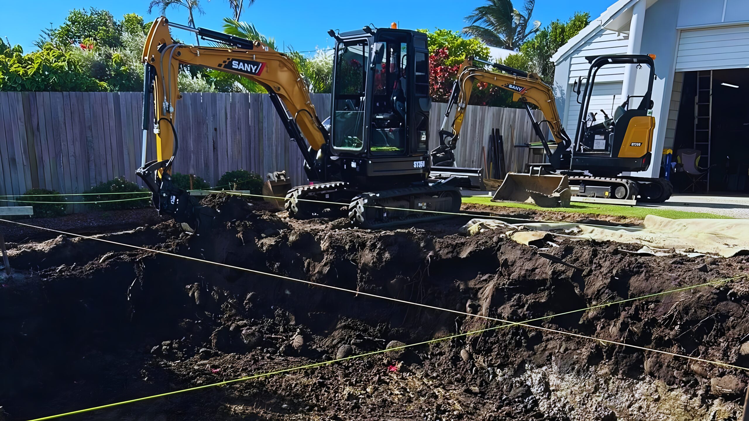 Heavy machinery and excavators at a Bundaberg earthworks site, specializing in large-scale residential clearing.