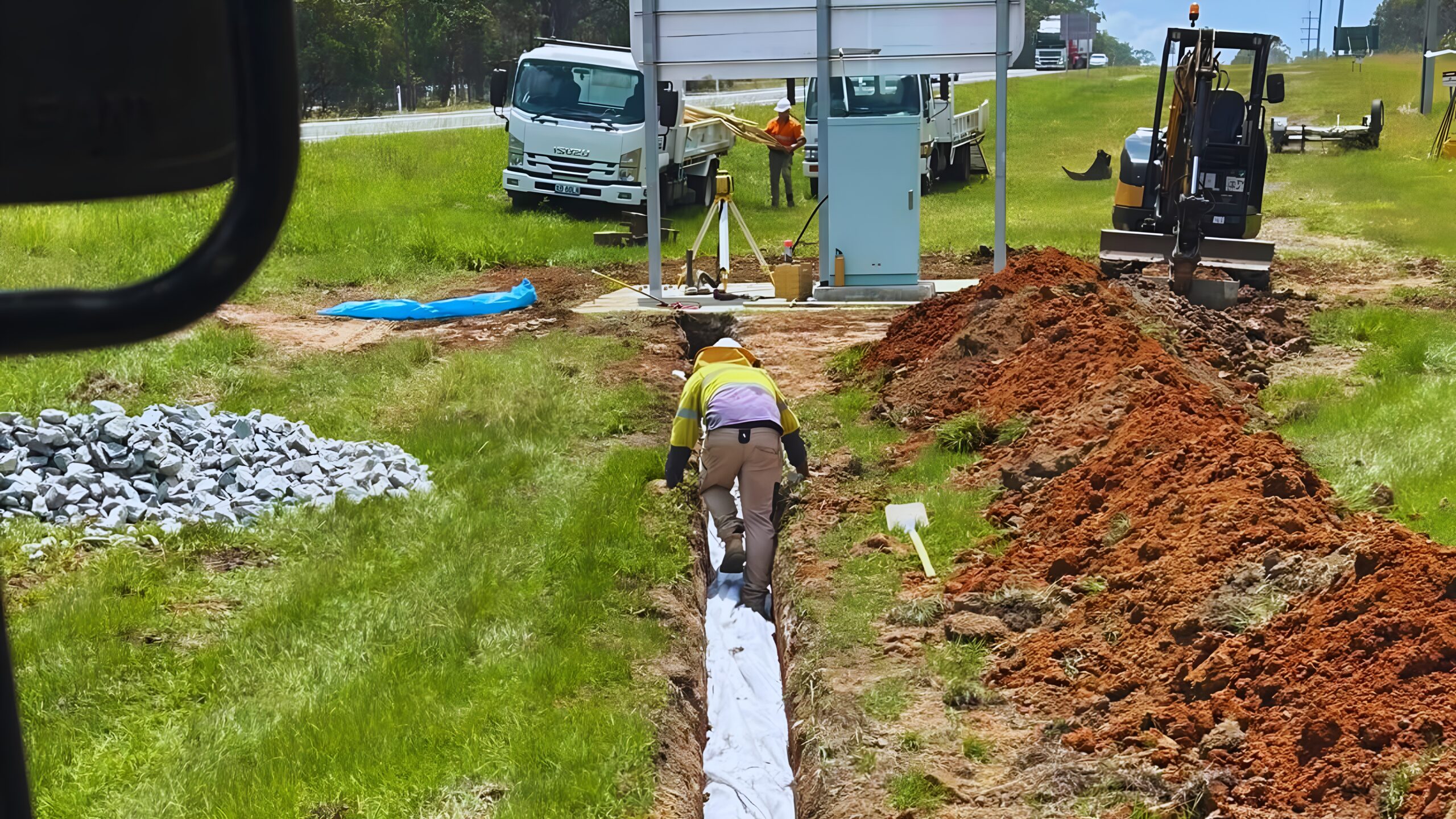 Earthmoving equipment performing post hole digging for rural and residential fencing sites in Bundaberg.